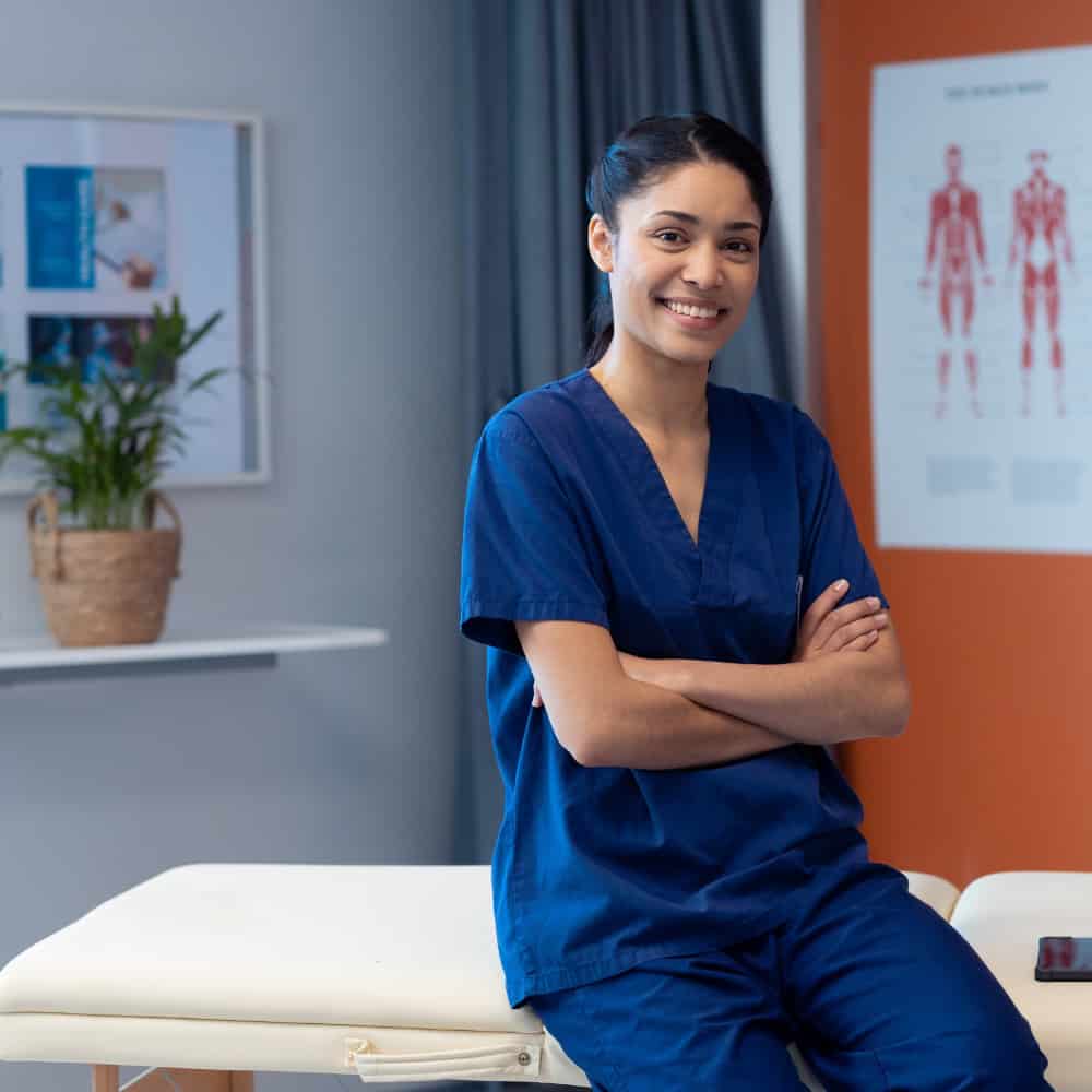 Smiling female physiotherapist in scrubs